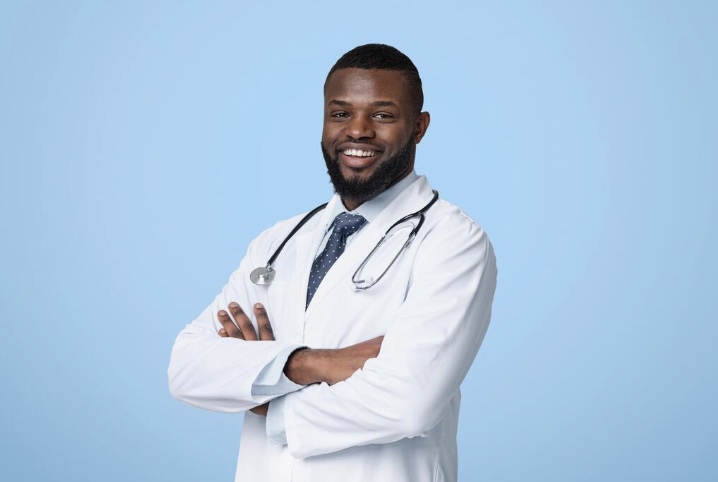 Carrington Spencer Williams, founder of Helping Hands, wearing a white coat and stethoscope